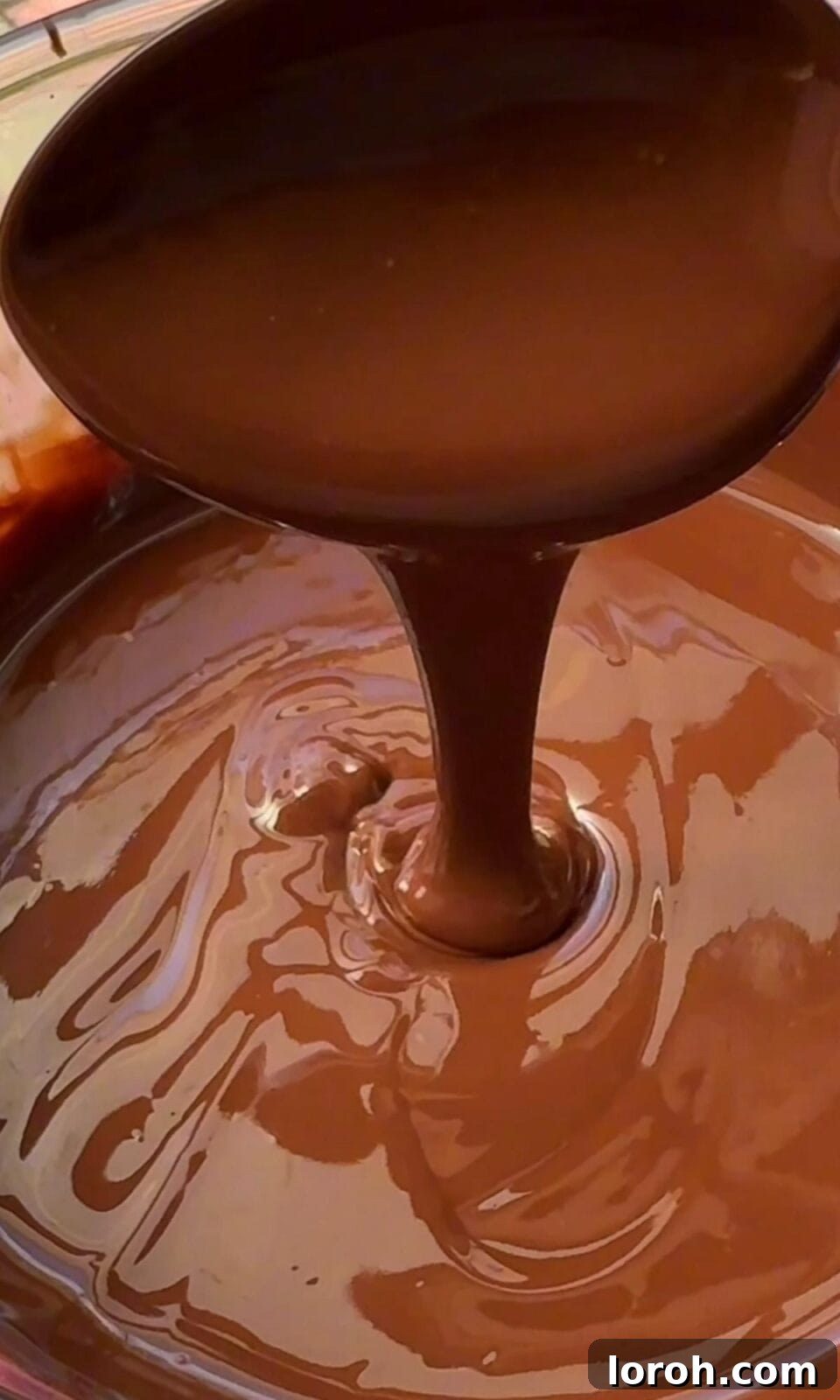 Melted milk chocolate in a bowl, ready for drizzling.