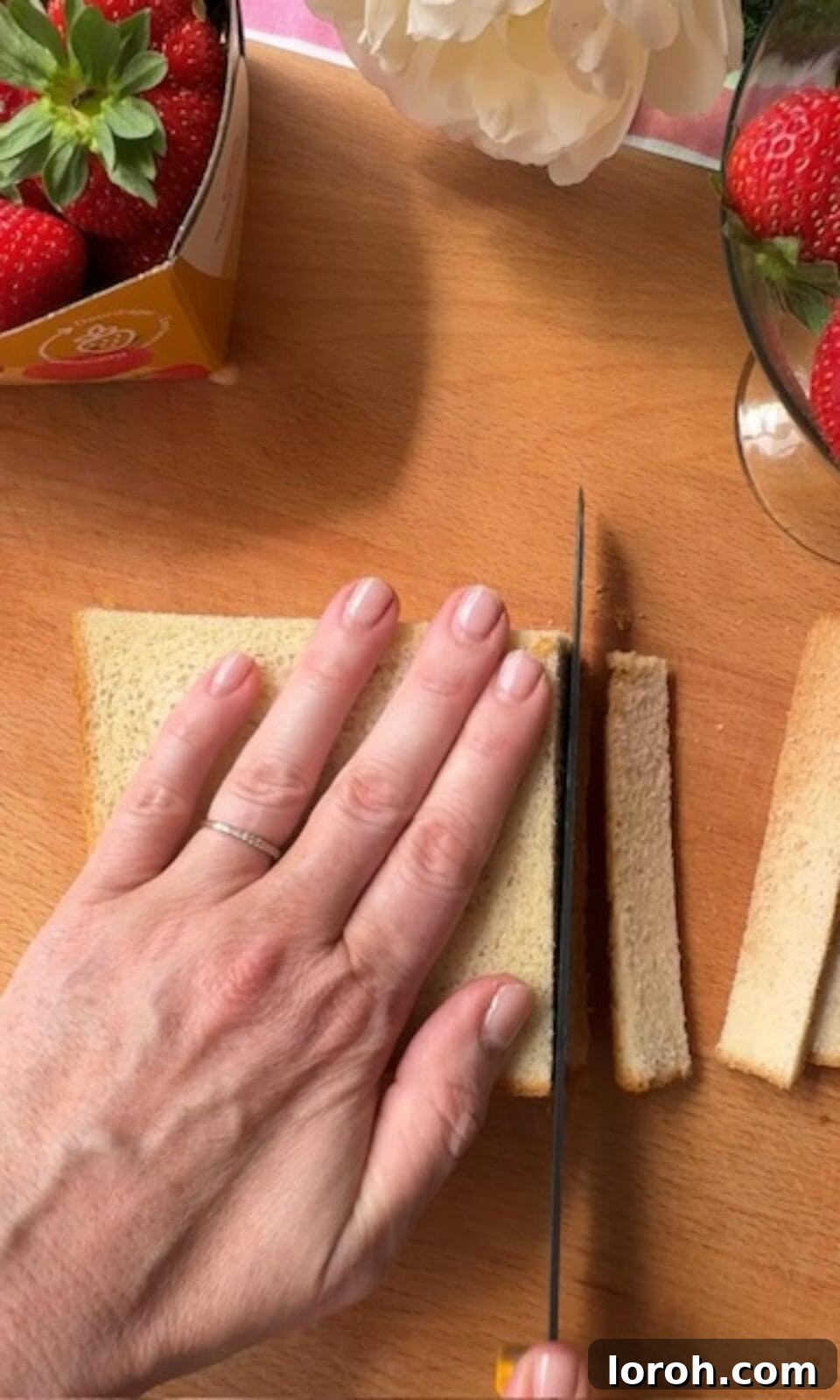 Removing crusts from soft Japanese milk bread slices for Ichigo Sando preparation.