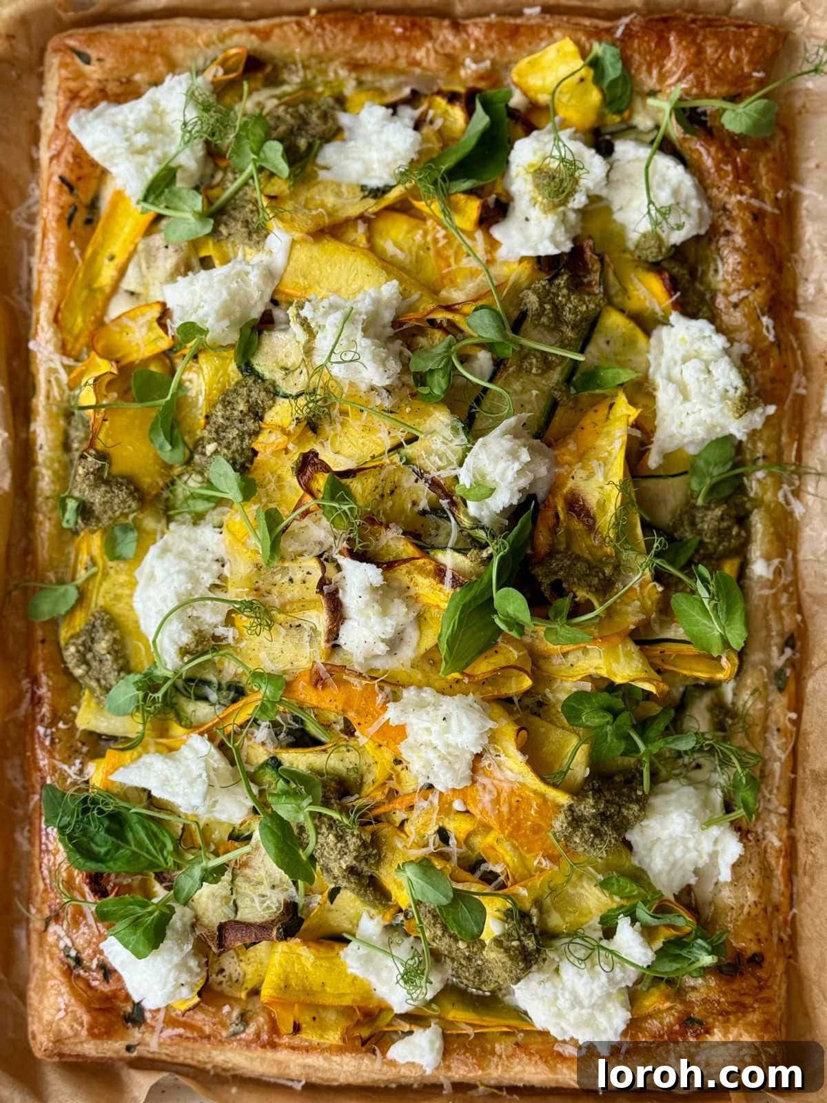 Golden Zucchini Tart 2 Golden brown courgette tart topped generously with melted mozzarella and fresh green pesto.