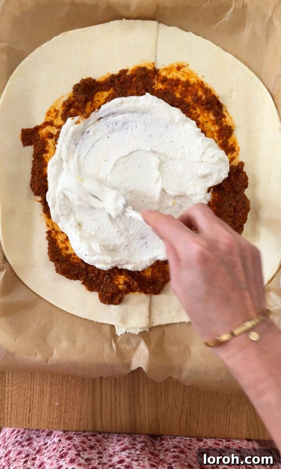 Golden Zucchini Feta Galette 5 Spreading red pesto and ricotta cheese mixture evenly over the puff pastry, leaving a border.