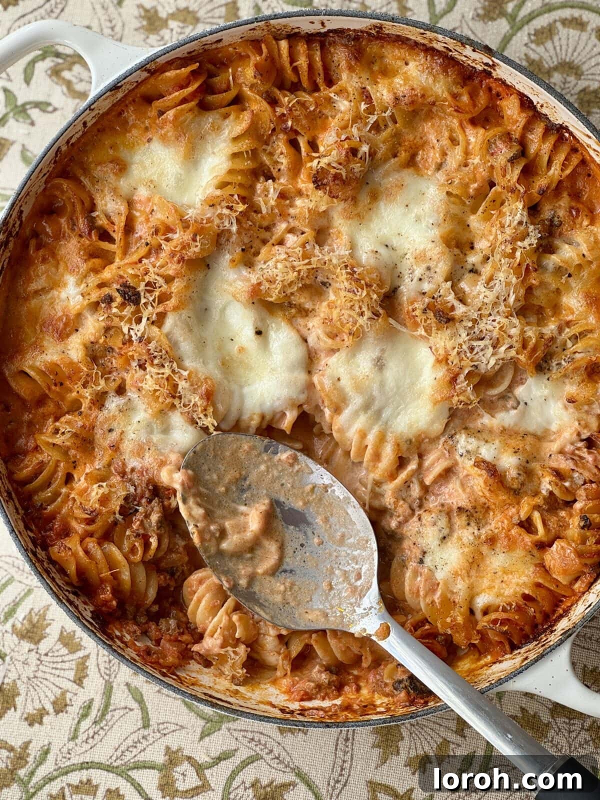 Hearty Bolognese Casserole 2 Delicious and comforting Bolognese pasta bake with a serving spoon, ready to be enjoyed.