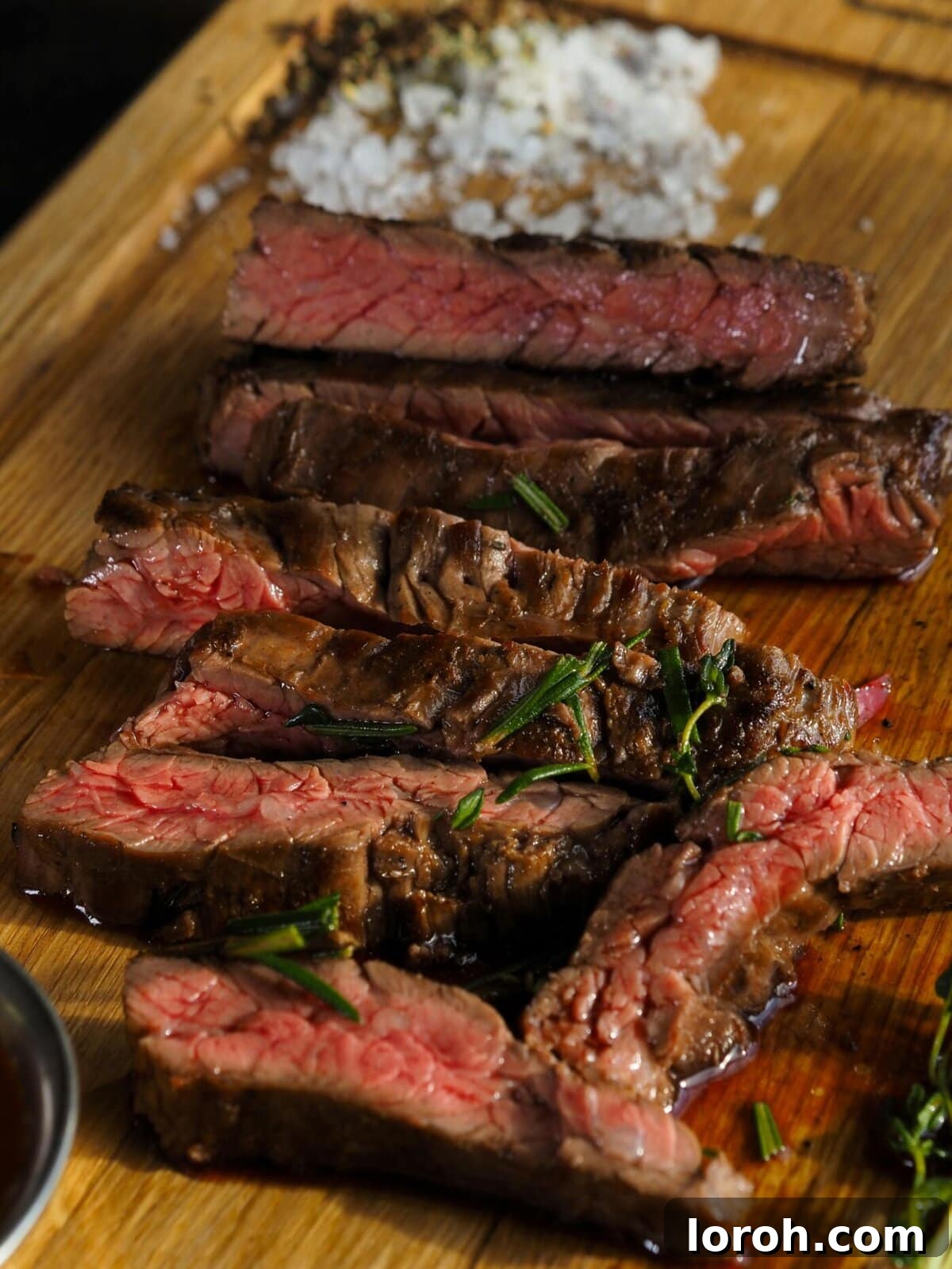 The Art of Perfect Rump Steak: A Comprehensive Guide 2 Perfectly sliced rump steak on a rustic wooden board, ready to be served.