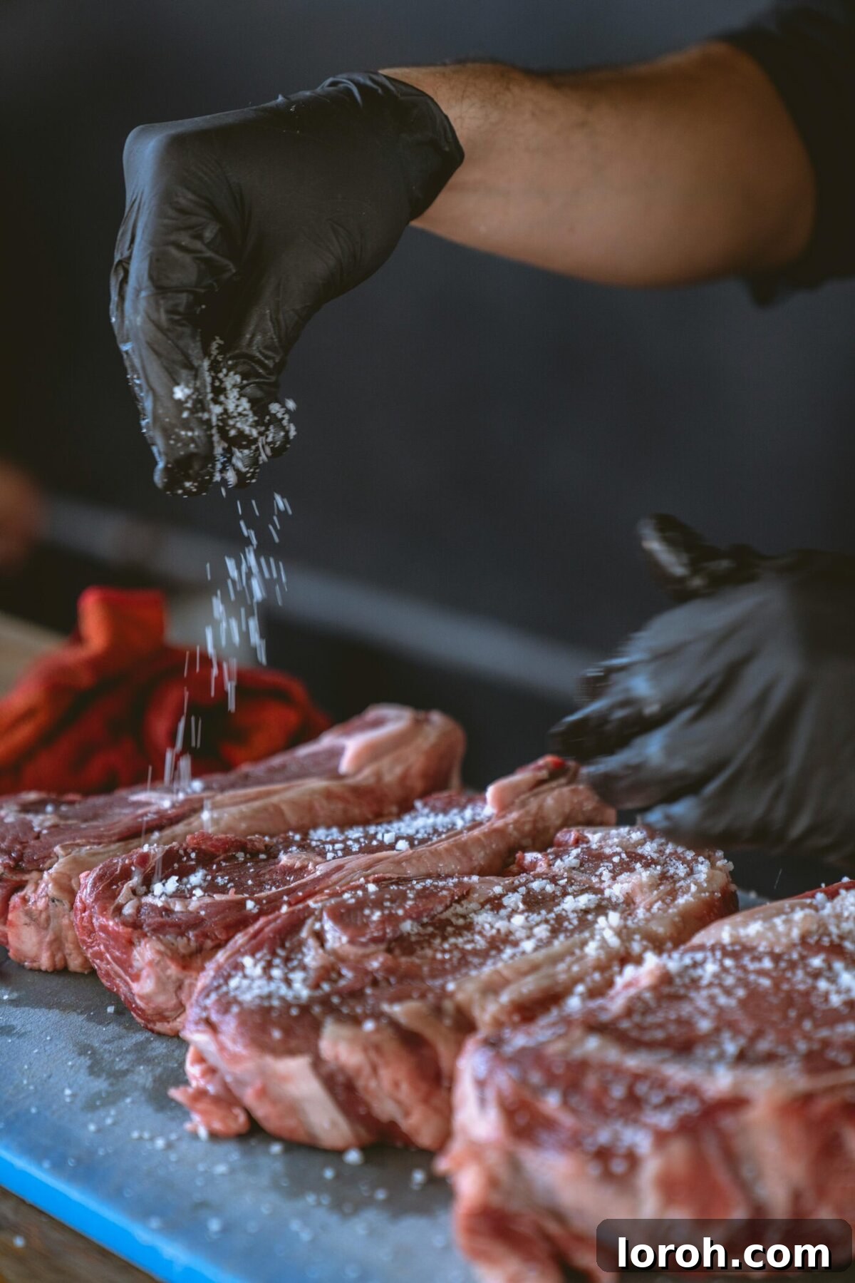 The Art of Perfect Rump Steak: A Comprehensive Guide 4 Expertly seasoning a rump steak with salt and pepper before cooking.