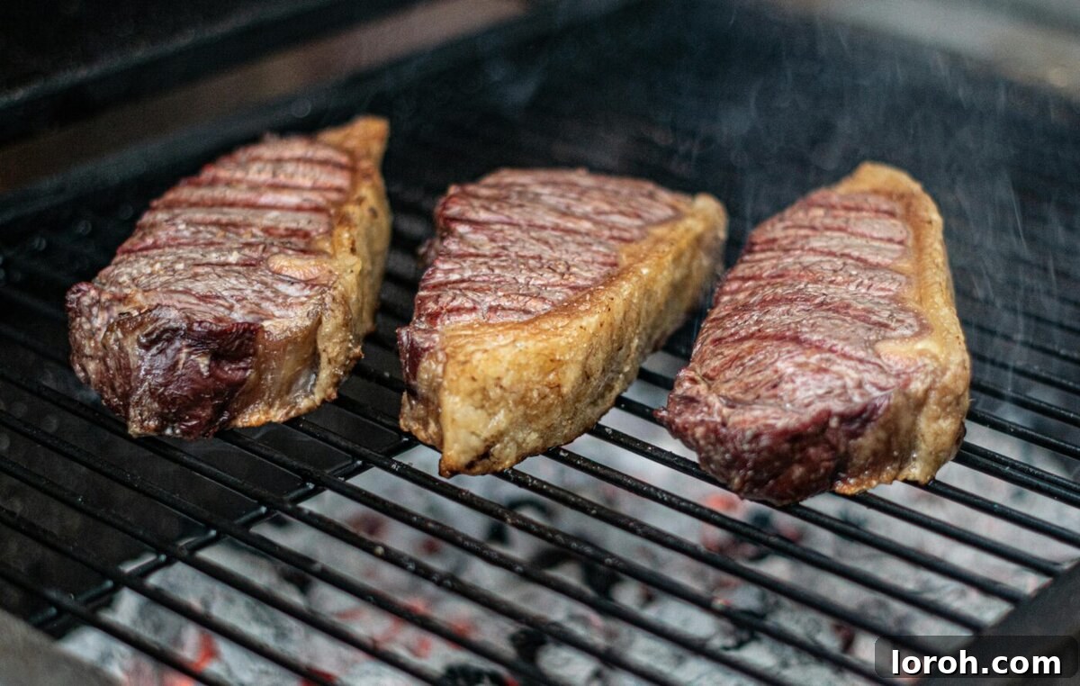 perfectly grilled sirloin steak on a rustic wooden board, ready to be sliced.