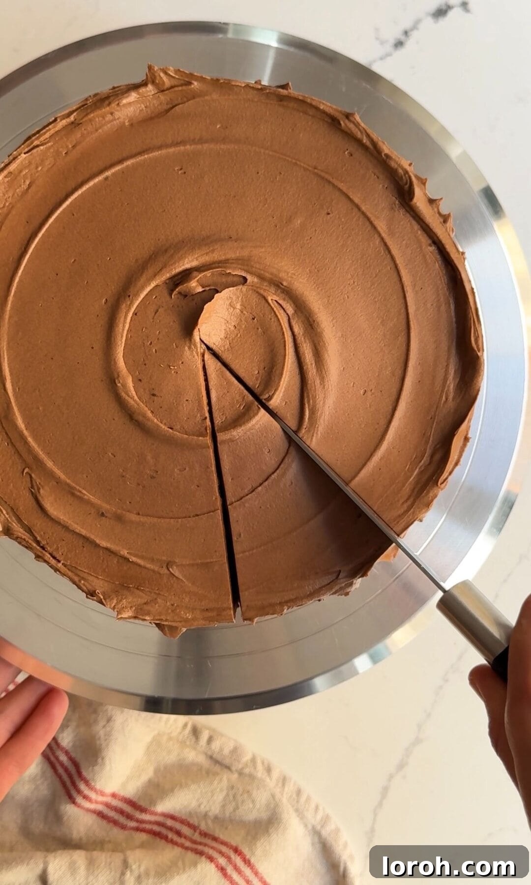 Decadent Chocolate Fudge Cake 14 A finished chocolate fudge cake, fully frosted and being sliced into serving portions, revealing its moist interior.