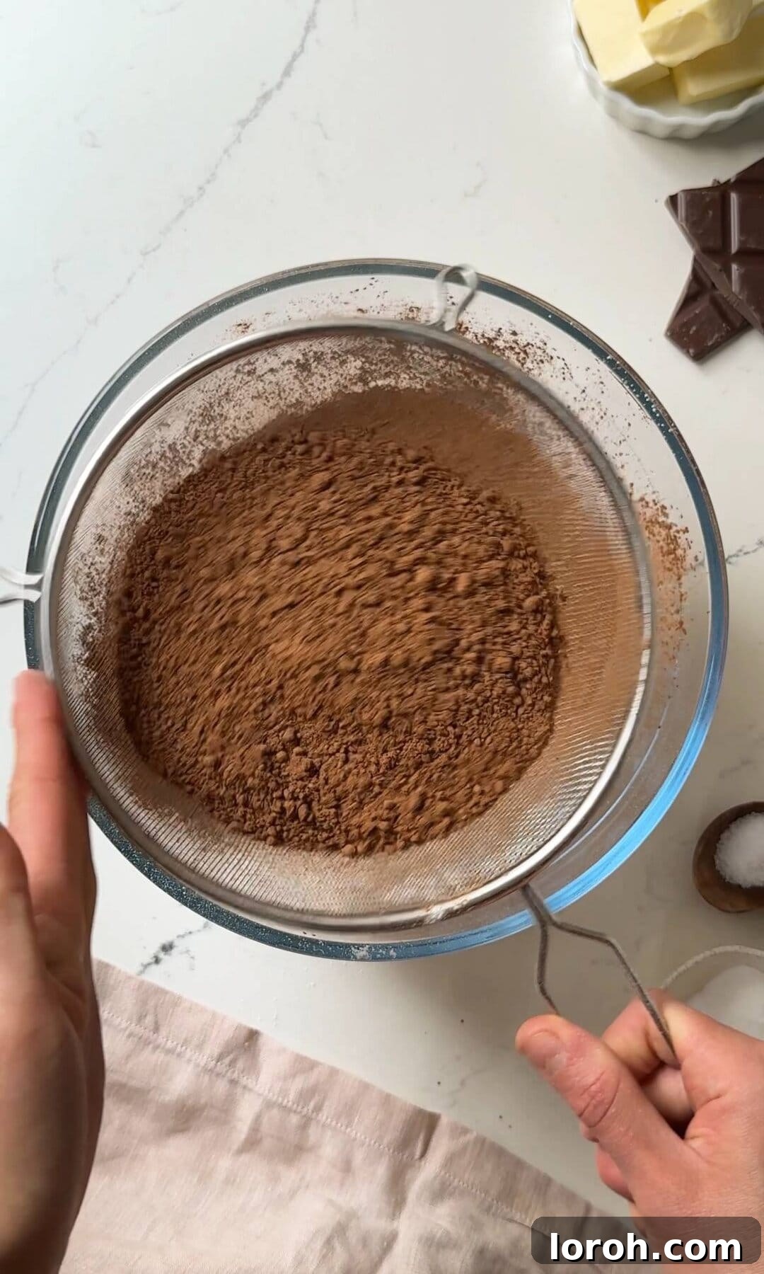 Decadent Chocolate Fudge Cake 6 Sifting dry ingredients: all-purpose flour, cocoa powder, baking powder, and bicarbonate of soda into the wet mixture.