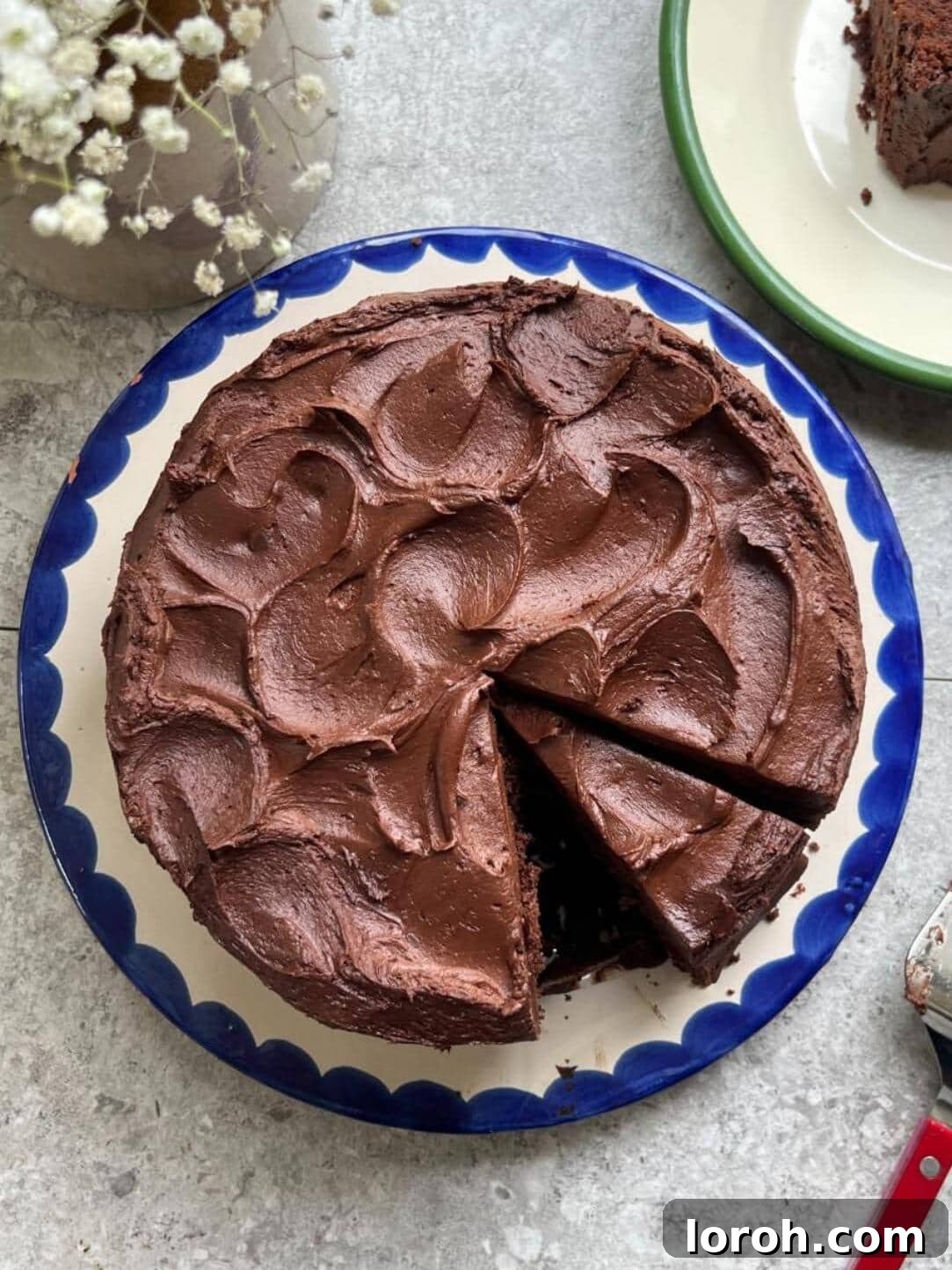 Matilda's chocolate cake on a white plate with blue trim, ready to be served.