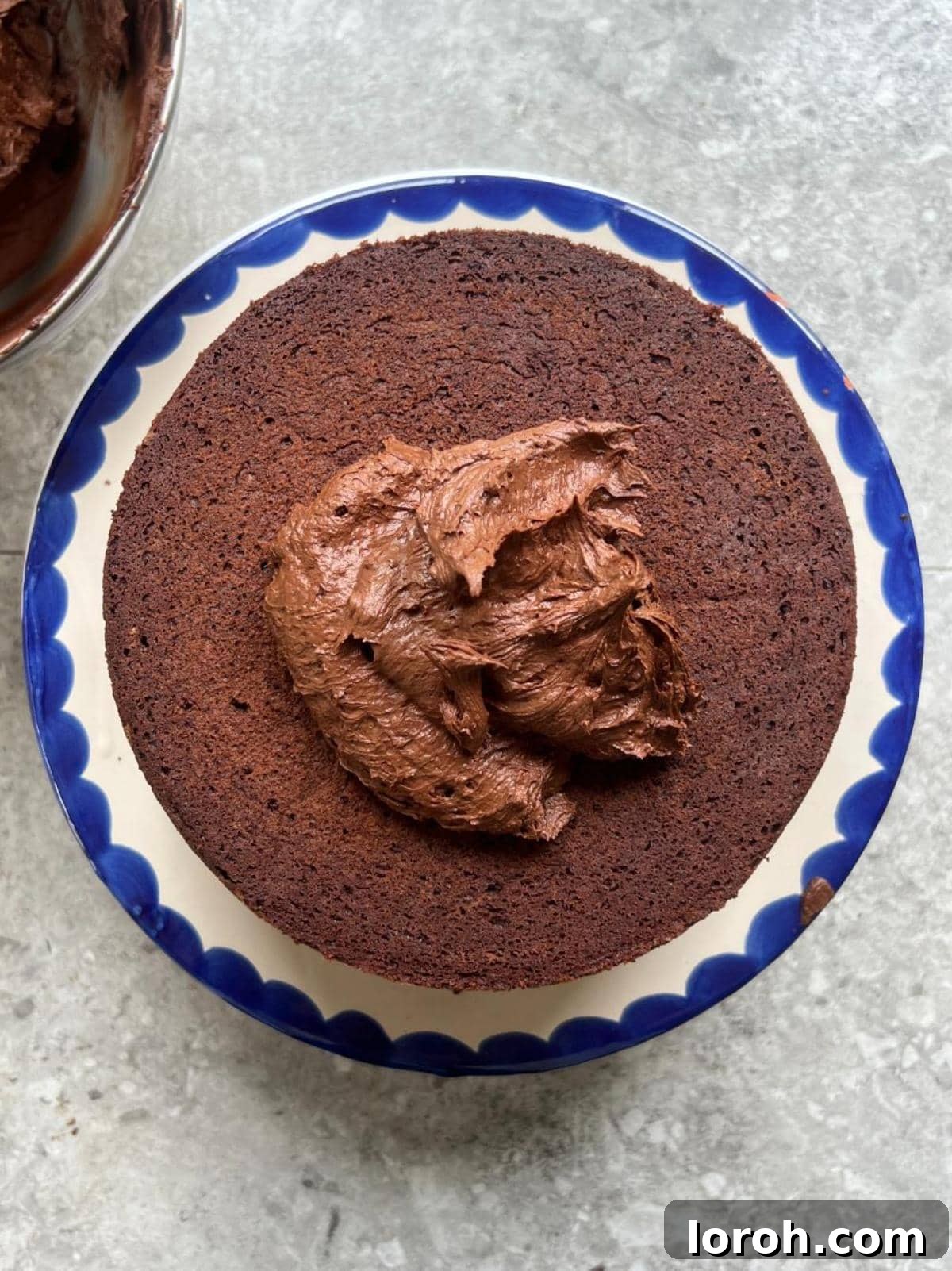 Placing the first chocolate cake sponge layer on a serving plate.