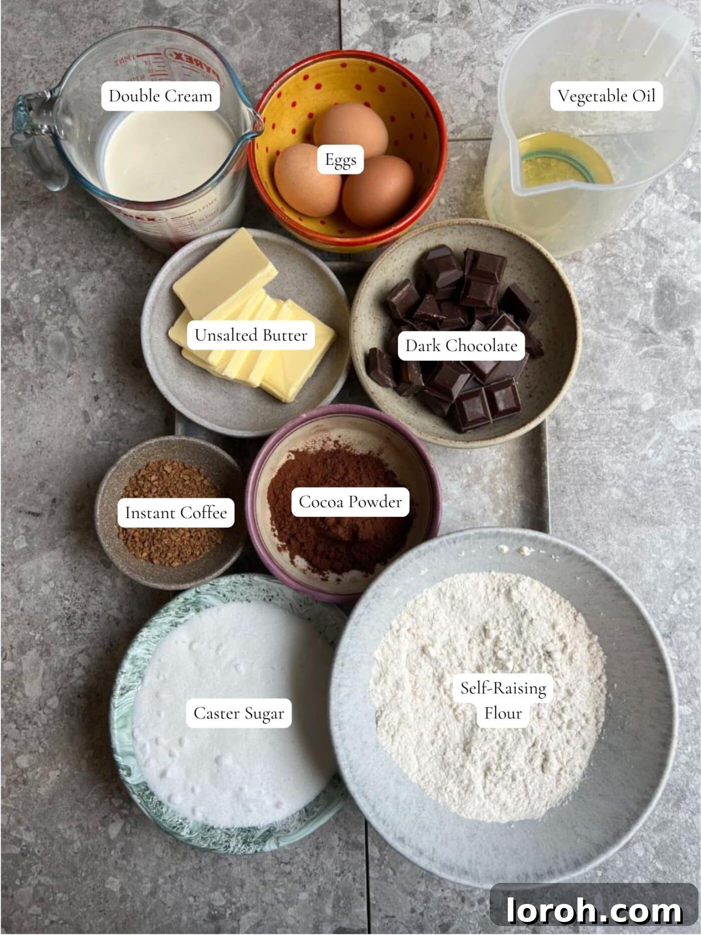 Labeled ingredients for Matilda's chocolate cake including cocoa, oil, coffee, flour, and cream.