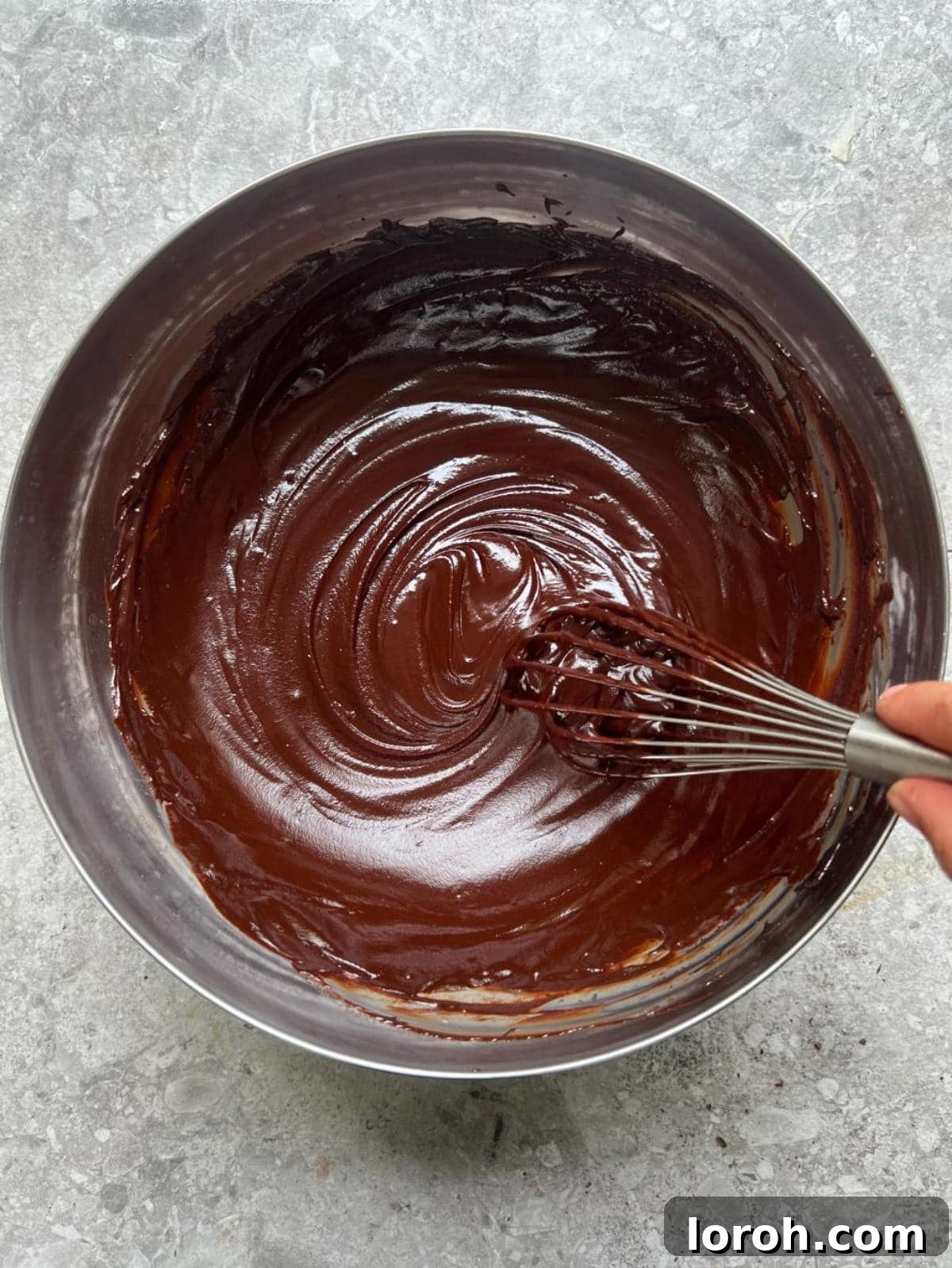 Smooth, melted chocolate ganache in a bowl after whisking.