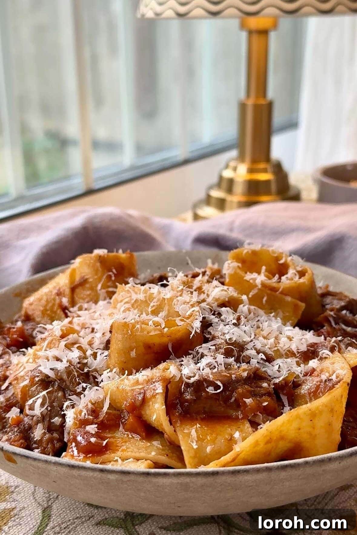 Close-up of beef short ribs ragu simmering, ready to be served.