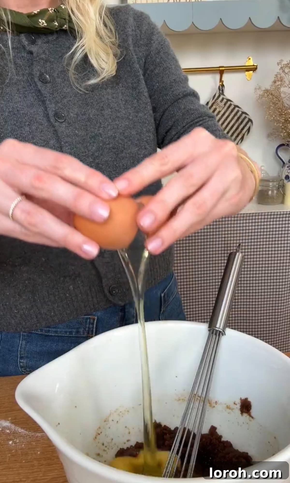 Silky Soft Chocolate Rounds 6 Adding eggs to the creamed butter and sugar mixture.