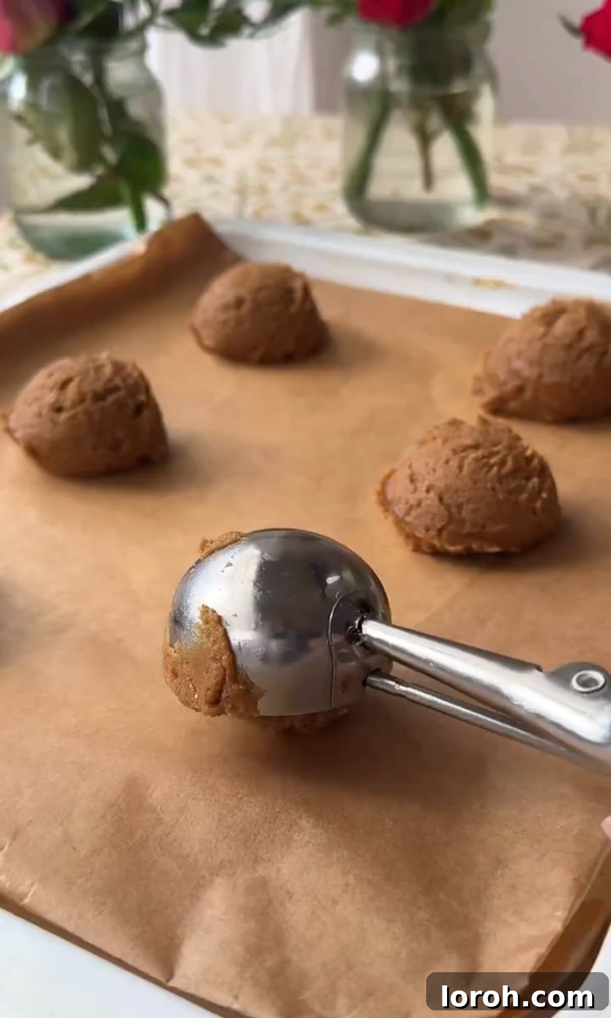 Silky Soft Chocolate Rounds 8 Scooping cookie dough onto a baking sheet, ready for baking.