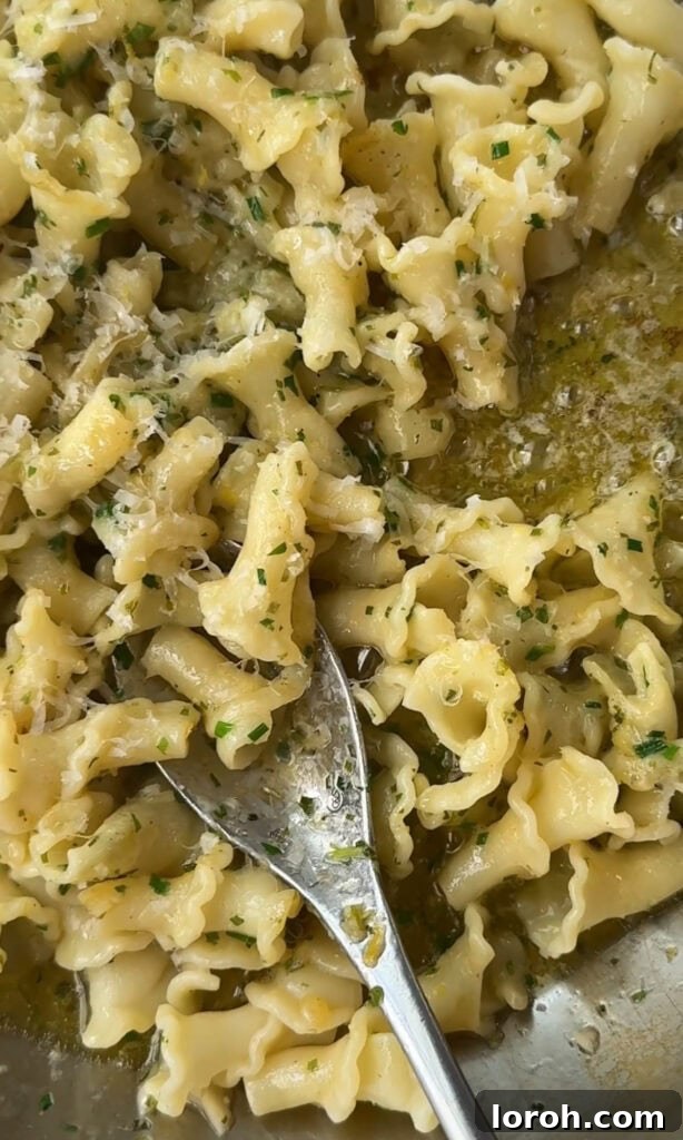 Fast Cowboy Butter Fix 6 Hot pasta being tossed with melted cowboy butter and Parmesan cheese, showcasing a simple yet incredibly flavorful dish.