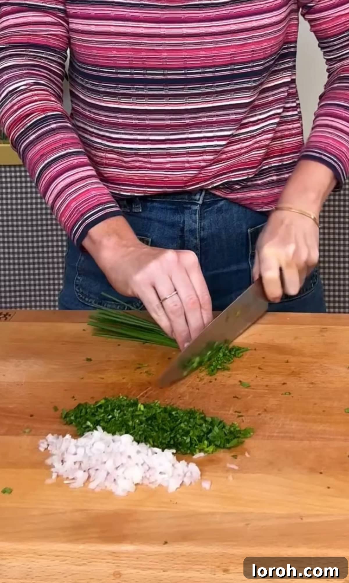 Fast Cowboy Butter Fix 7 A close-up of finely chopped fresh parsley, chives, shallot, and grated garlic cloves on a cutting board, ready for mixing.