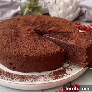 torta caprese with a slice being removed from the cake.