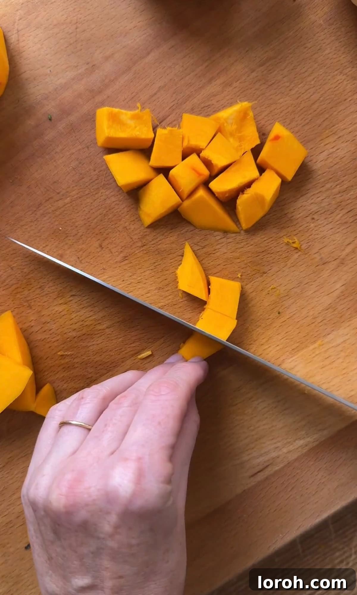Golden Harvest Pumpkin Risotto 4 Cubed pumpkin pieces arranged on a baking sheet, ready for roasting.