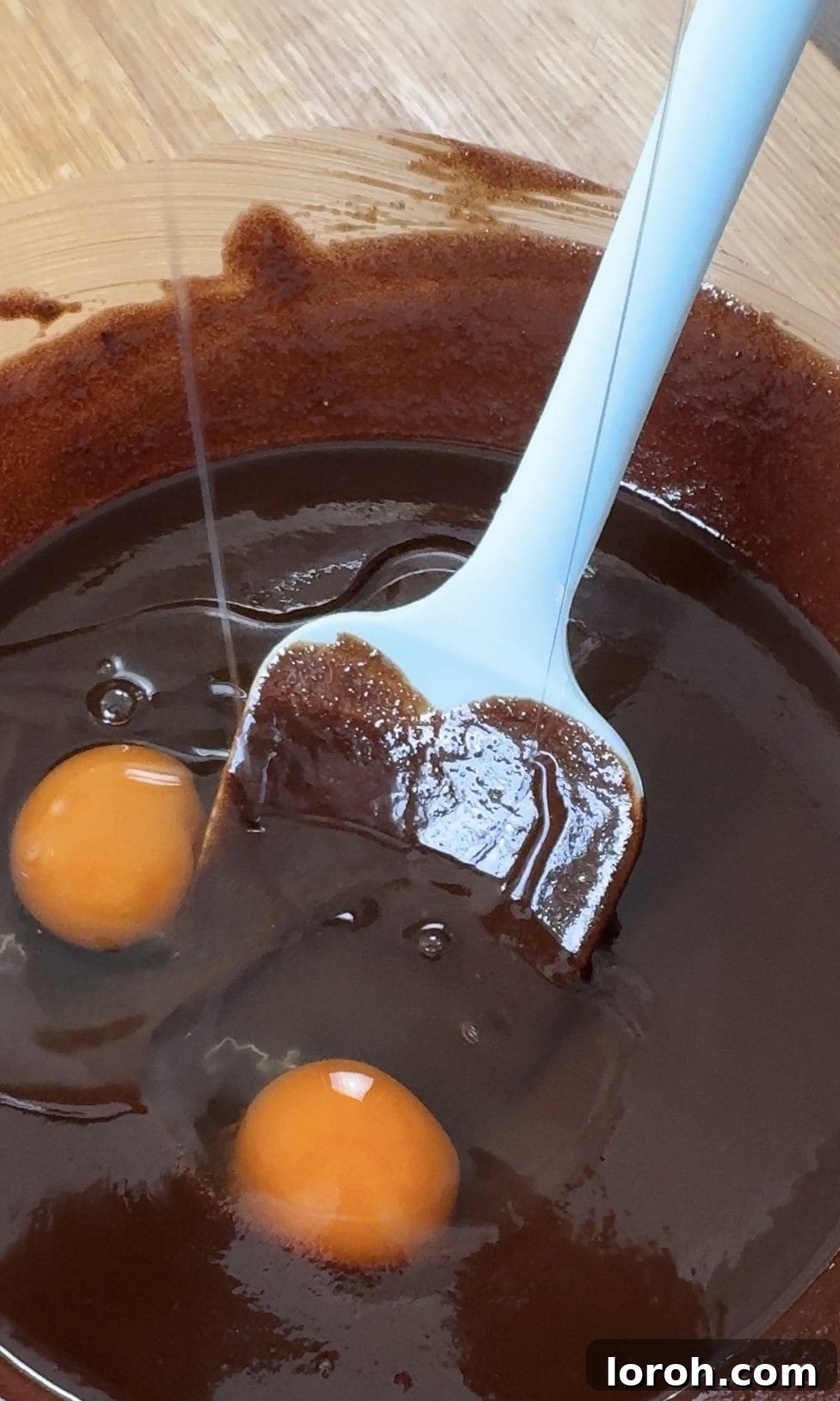 Decadent Cheesecake Brownies 5 Stirring sugar and eggs into melted chocolate mixture.