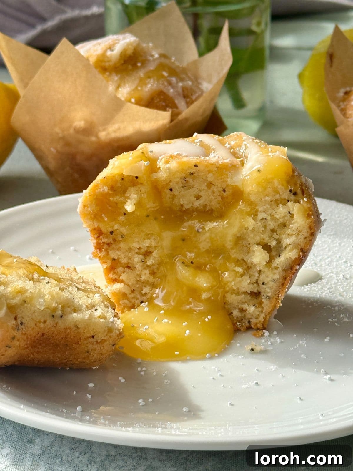 Zesty Lemon Poppy Seed Delights 12 A cross-section of a moist lemon and poppy seed muffin, revealing its tender crumb and inner lemon curd filling.