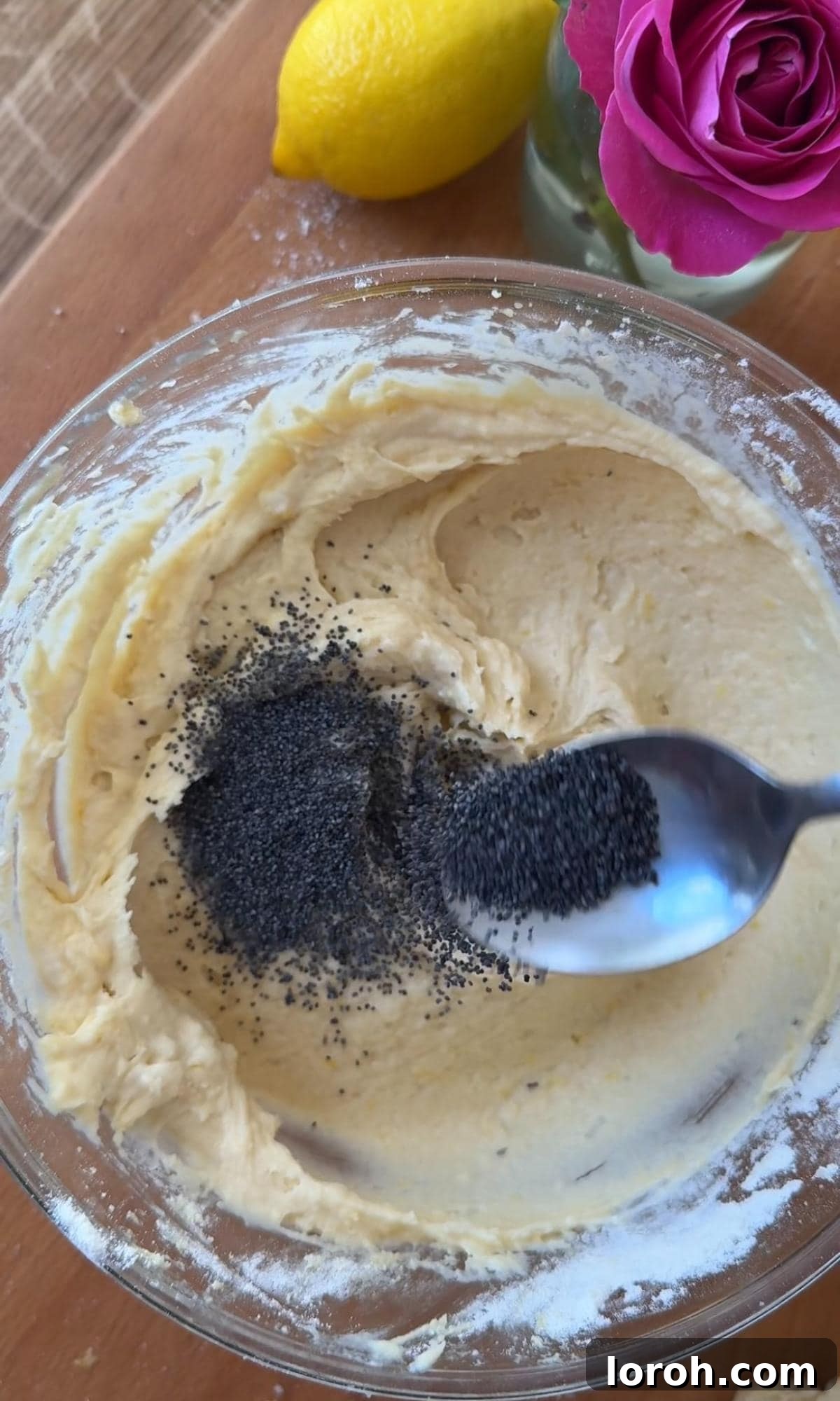 Zesty Lemon Poppy Seed Delights 8 Gently folding poppy seeds into the muffin batter, ensuring even distribution.