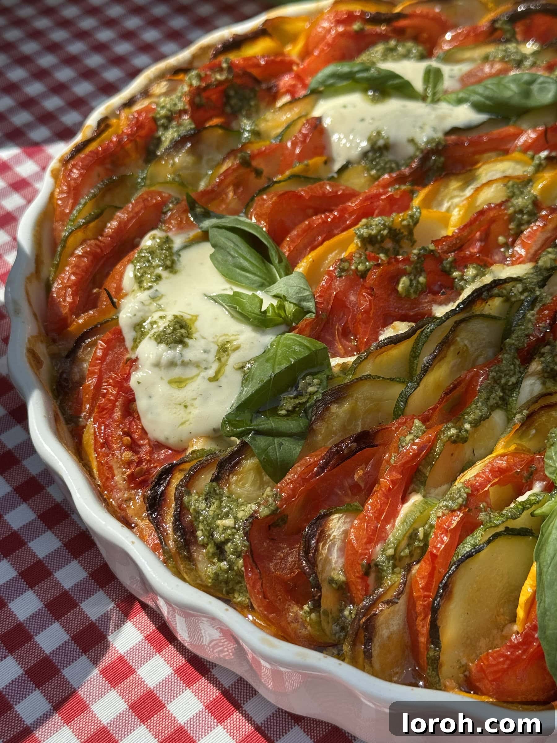 Beautifully assembled Zucchini Al Forno with layered tomatoes and courgettes, ready for baking.