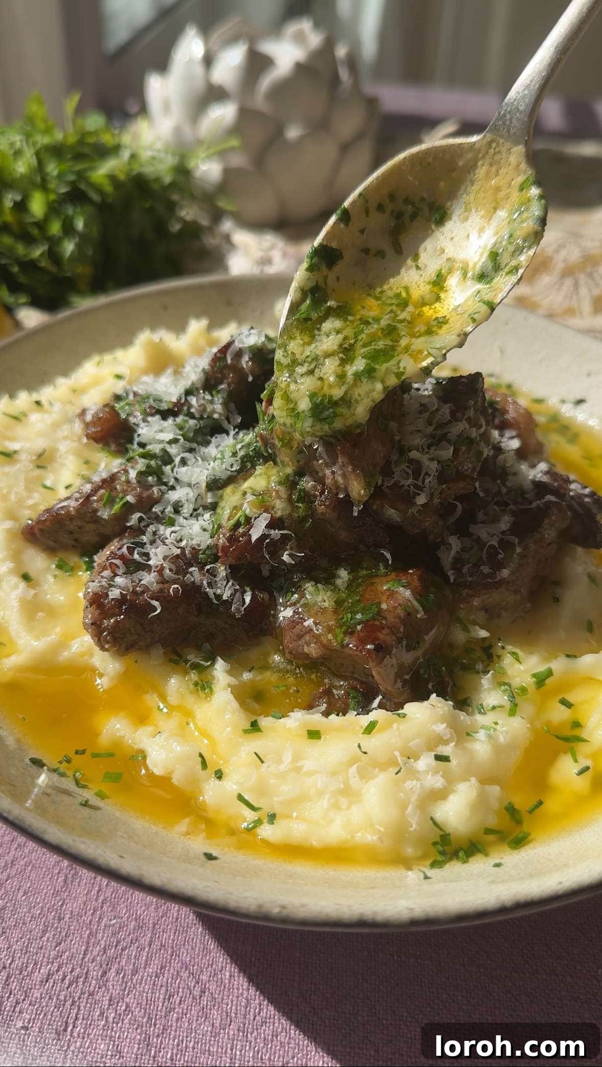 Melt-in-Your-Mouth Garlic Butter Steak Bites 2 Pouring rich garlic butter over perfectly seared steak bites, glistening with flavor.