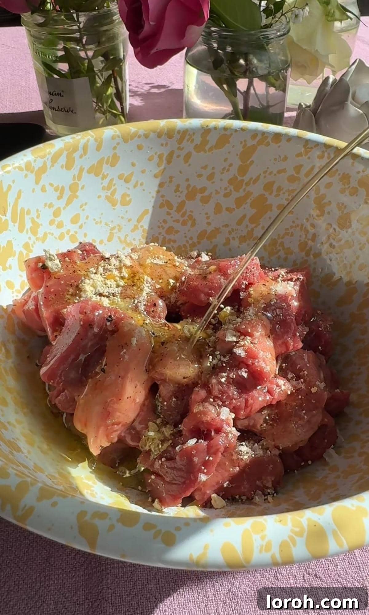 Melt-in-Your-Mouth Garlic Butter Steak Bites 4 Steak cubes generously seasoned with salt, pepper, and garlic powder on a cutting board.