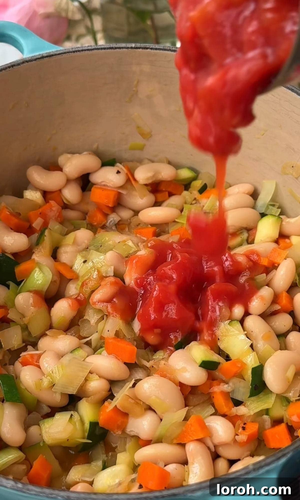 Rustic Tomato and Bean Stew with Cavolo Nero 5 Adding canned cannellini beans and chopped tomatoes to the sautéed vegetables in the pan.