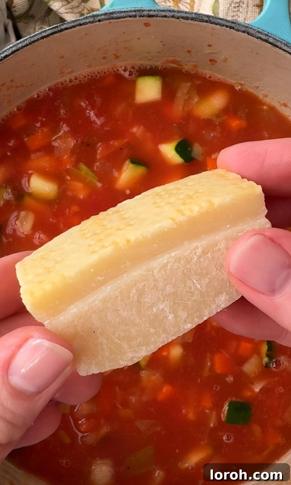 Rustic Tomato and Bean Stew with Cavolo Nero 7 Placing a piece of Parmesan rind into the bean stew mixture before simmering.