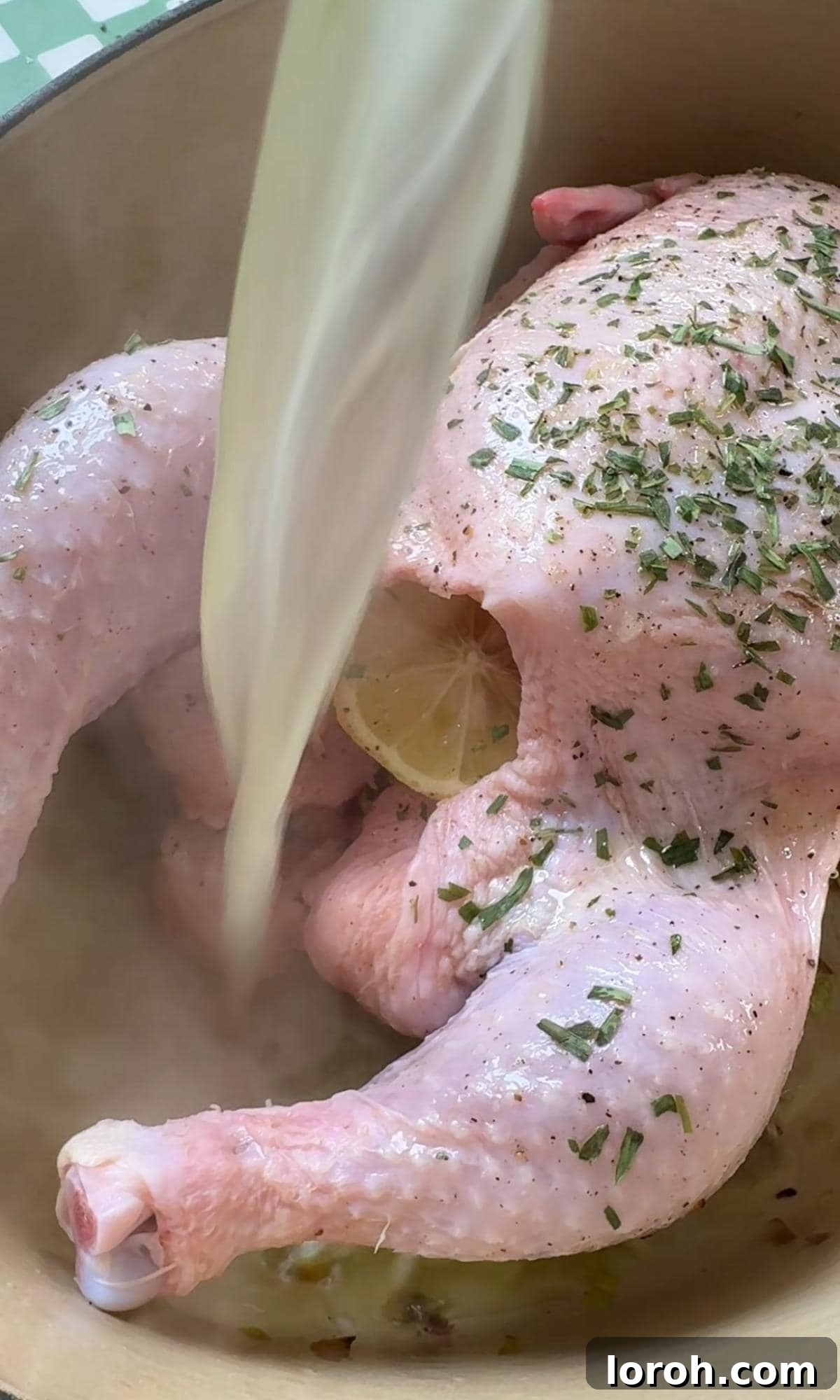 French Rustic Chicken Pot Roast 6 Adding chicken stock to the pot with the chicken and vegetables.