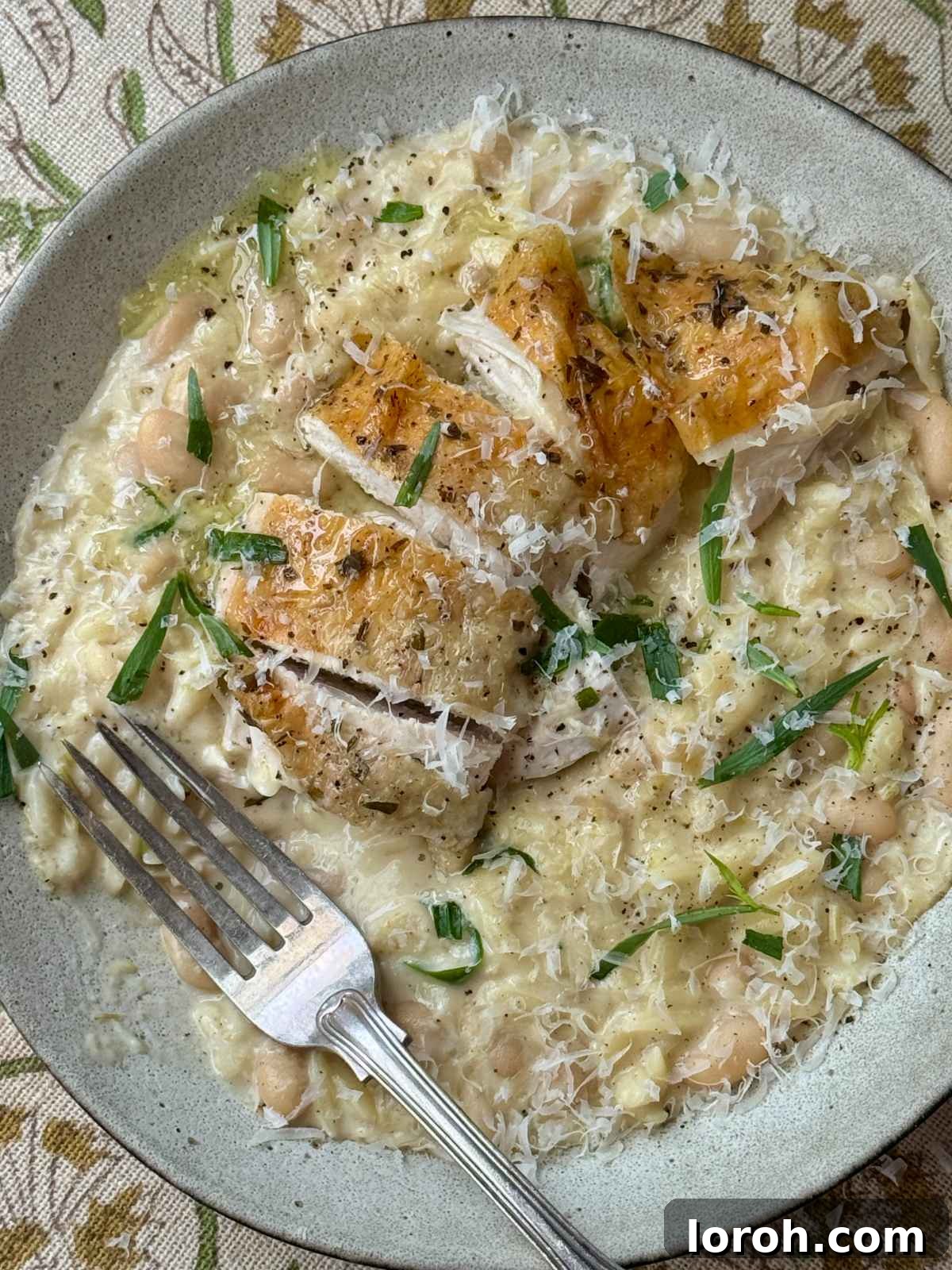 French Rustic Chicken Pot Roast 10 A perfectly cooked Poule au Pot served on a plate with creamy beans and orzo.