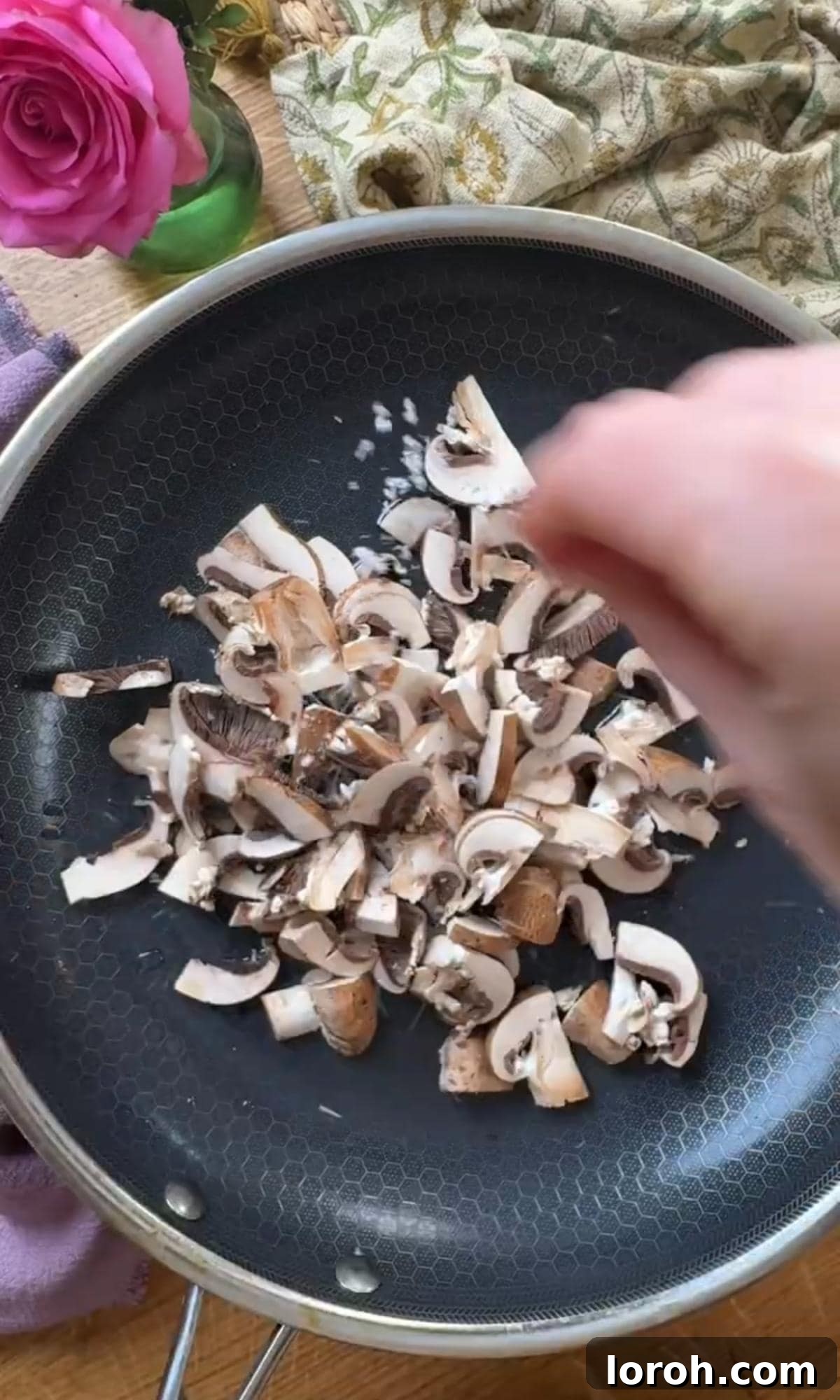 Velvety Chicken, Mushroom, and Leek Pie 4 Sautéing sliced mushrooms in a large frying pan until they begin to soften and release their moisture.