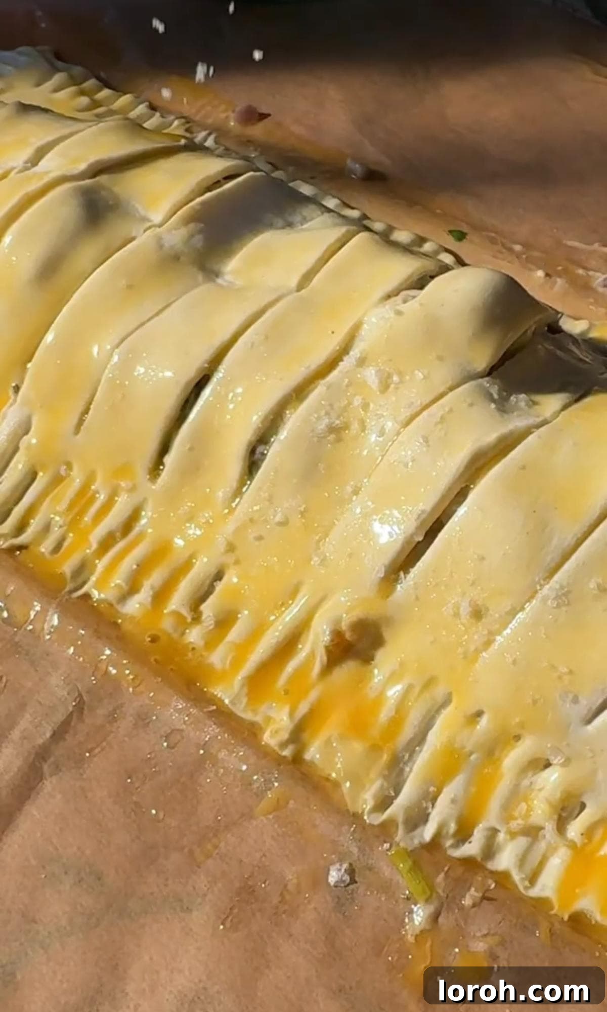 Velvety Chicken, Mushroom, and Leek Pie 9 Brushing the assembled 'cheat's plait' chicken pie with a beaten egg wash before baking to achieve a golden crust.