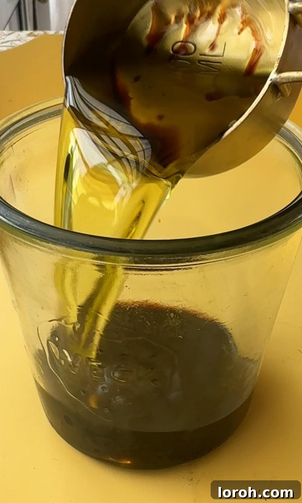 Ingredients for the dressing being added to a blender.