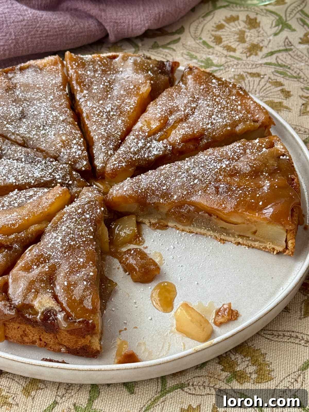 Golden Pear Flip Cake with Decadent Fudge Drizzle 2 A beautifully sliced fudgy upside-down pear cake on a pristine white plate, showcasing the caramelized pear topping and rich, moist crumb.