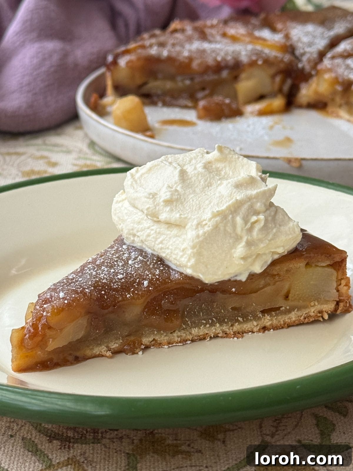 Golden Pear Flip Cake with Decadent Fudge Drizzle 3 A generous slice of fudgy upside-down pear cake, topped with a dollop of fresh whipped cream, ready to be enjoyed.