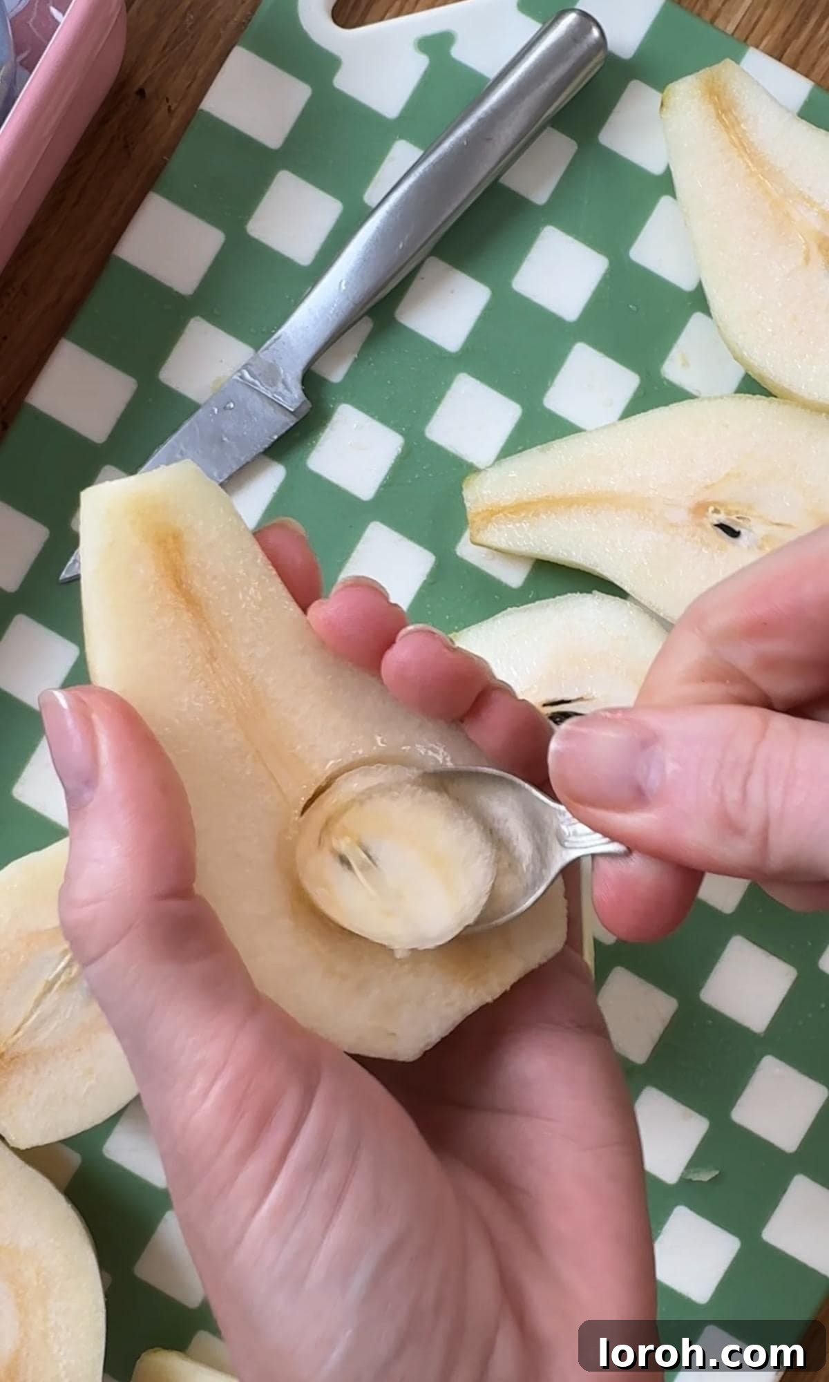 Golden Pear Flip Cake with Decadent Fudge Drizzle 4 Close-up of a pear being cored and thinly sliced on a cutting board, demonstrating preparation for the cake.