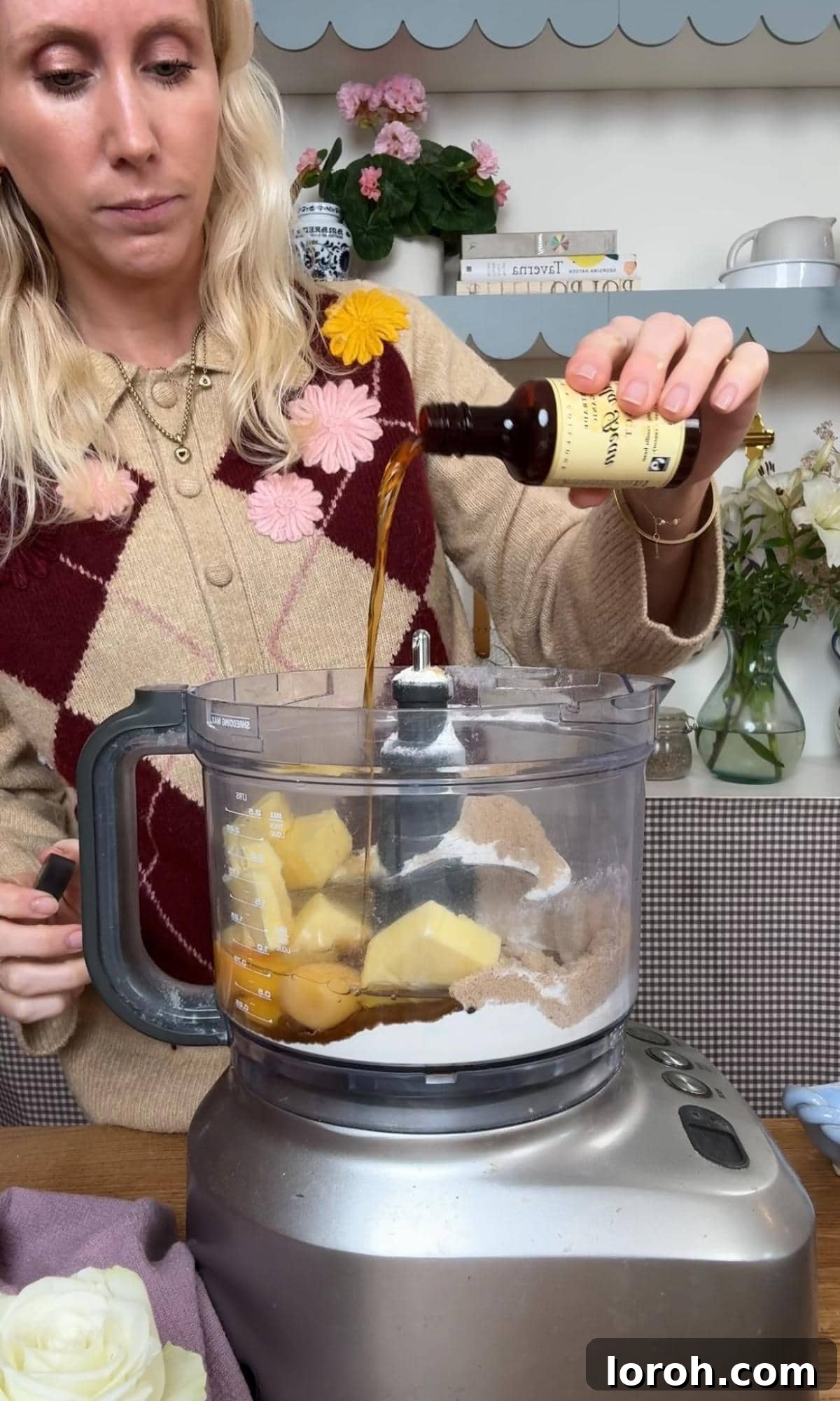 Golden Pear Flip Cake with Decadent Fudge Drizzle 7 Pouring vanilla extract into a food processor bowl containing butter, brown sugar, eggs, and flour for the cake batter.