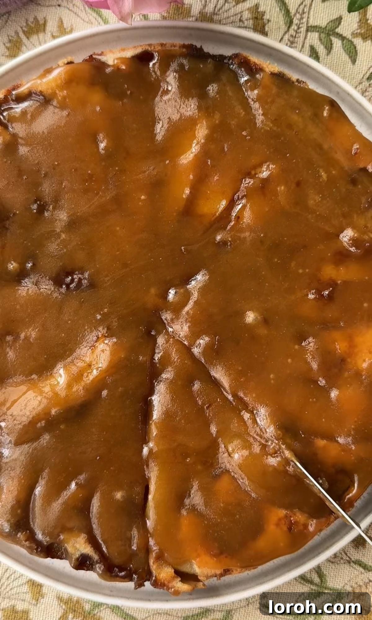 Golden Pear Flip Cake with Decadent Fudge Drizzle 9 Warm, glossy fudge sauce being generously poured over the freshly baked and inverted pear cake, creating a luxurious topping.