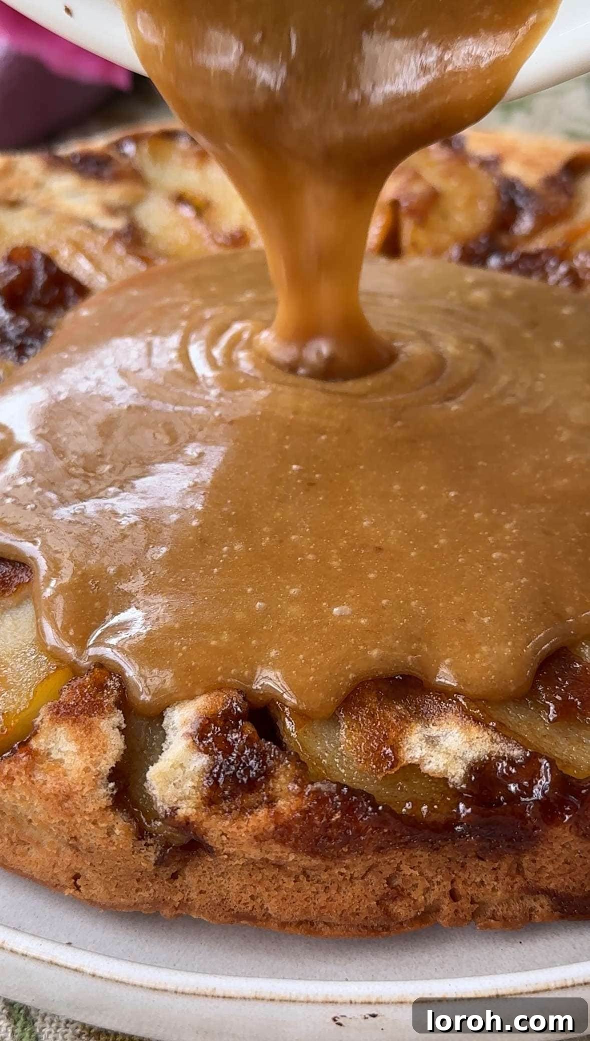 Golden Pear Flip Cake with Decadent Fudge Drizzle 10 A stream of rich, dark fudge sauce flowing over the inverted upside-down pear cake, glistening beautifully.
