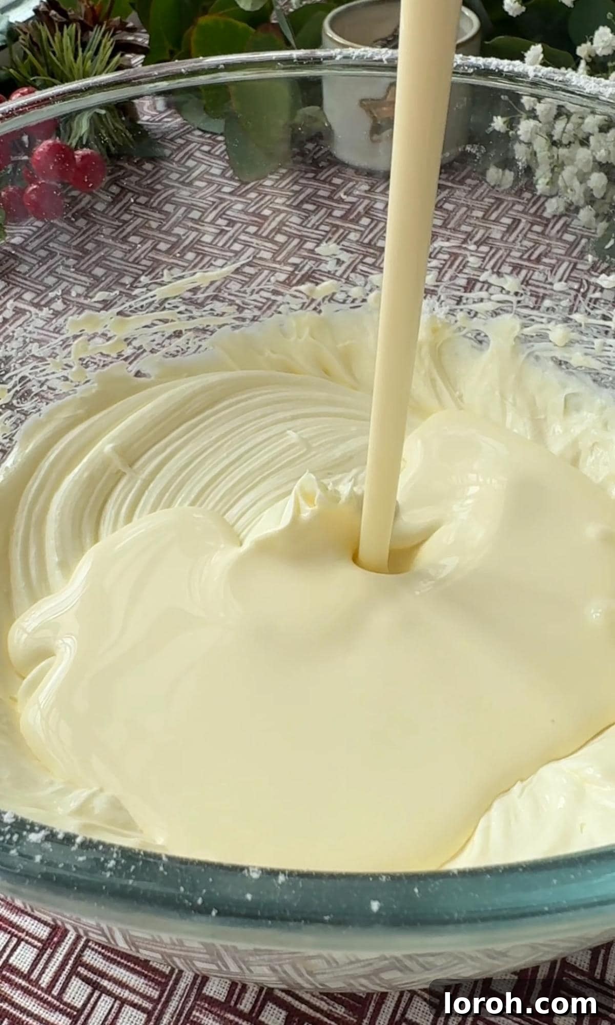 Effortless Christmas Cheesecake Bites 7 adding double cream to cheesecake mix.