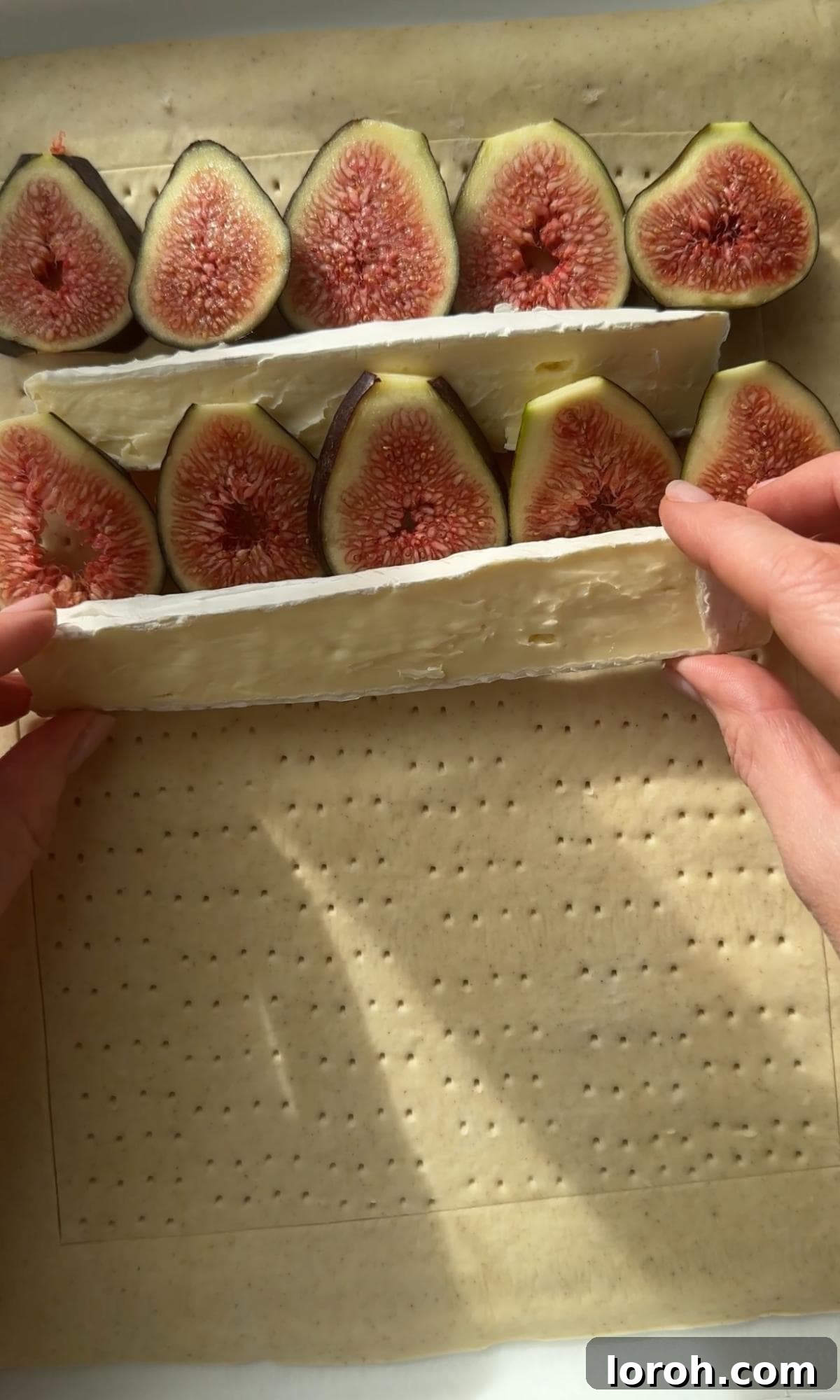 Fig and Brie Bliss Tart 5 Arranging slices of brie and figs in an alternating pattern on the pastry.