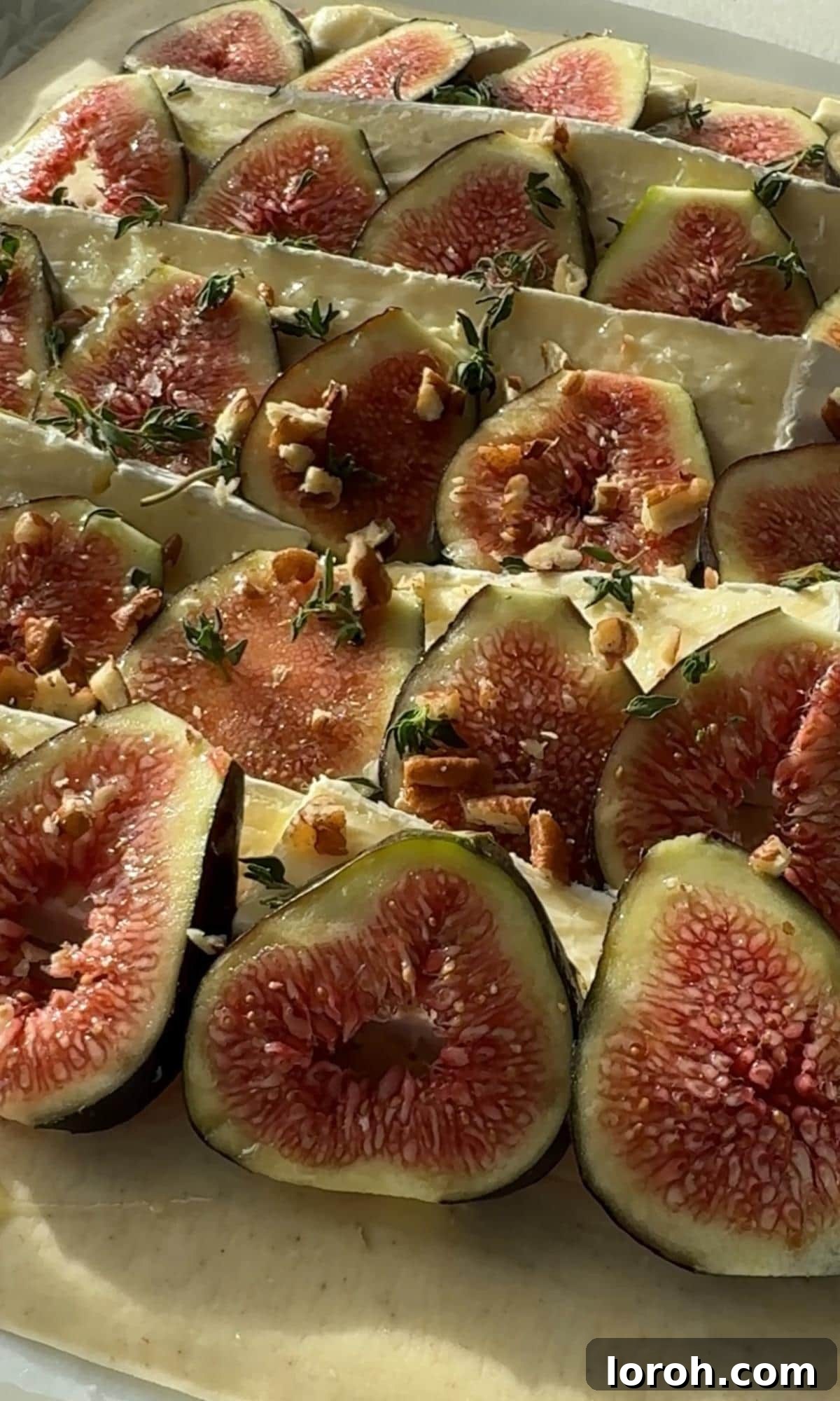 Fig and Brie Bliss Tart 6 The tarte aux figues garnished with walnuts and fresh thyme before baking.