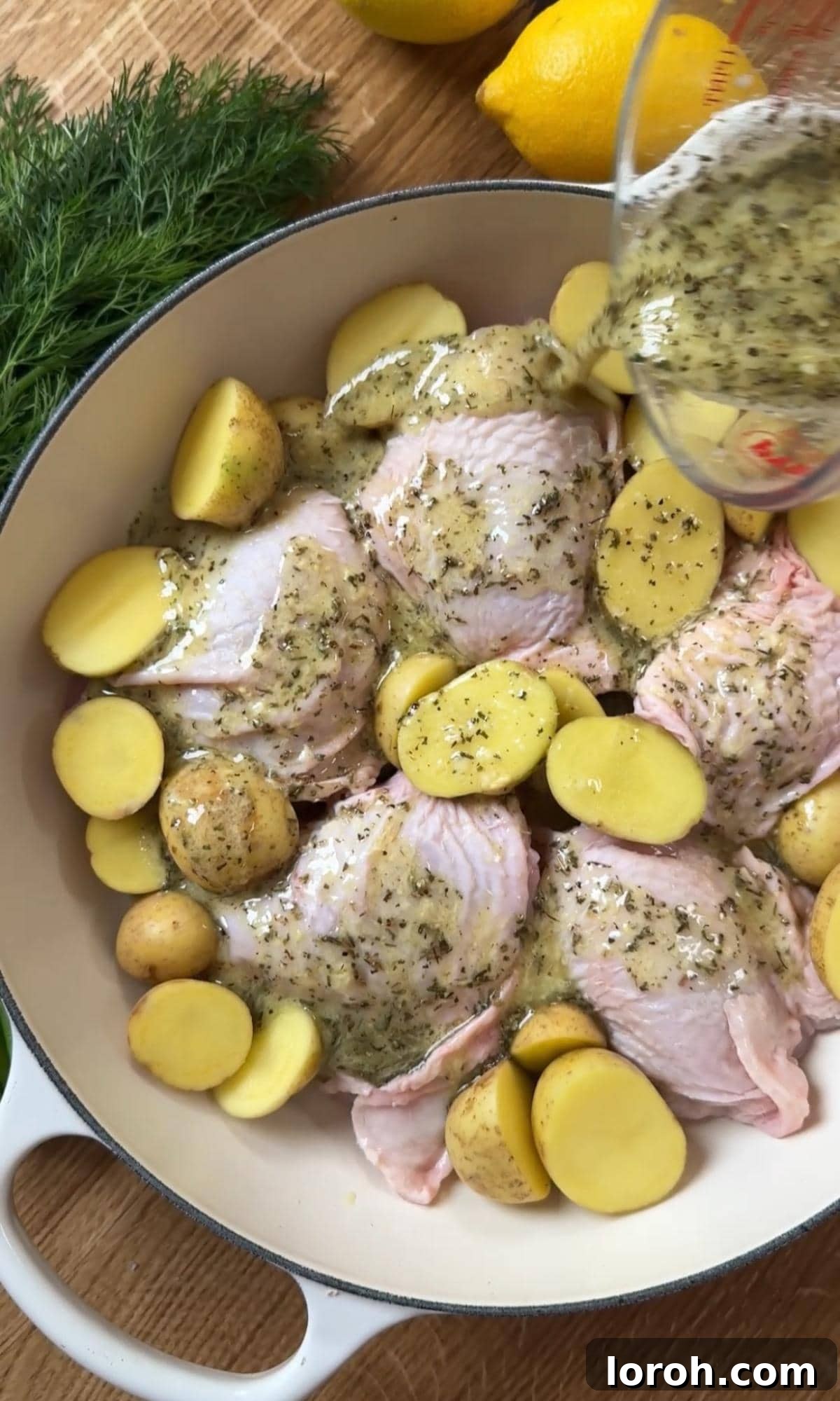 The chicken and potatoes, fully coated in the lemon marinade, ready for roasting.