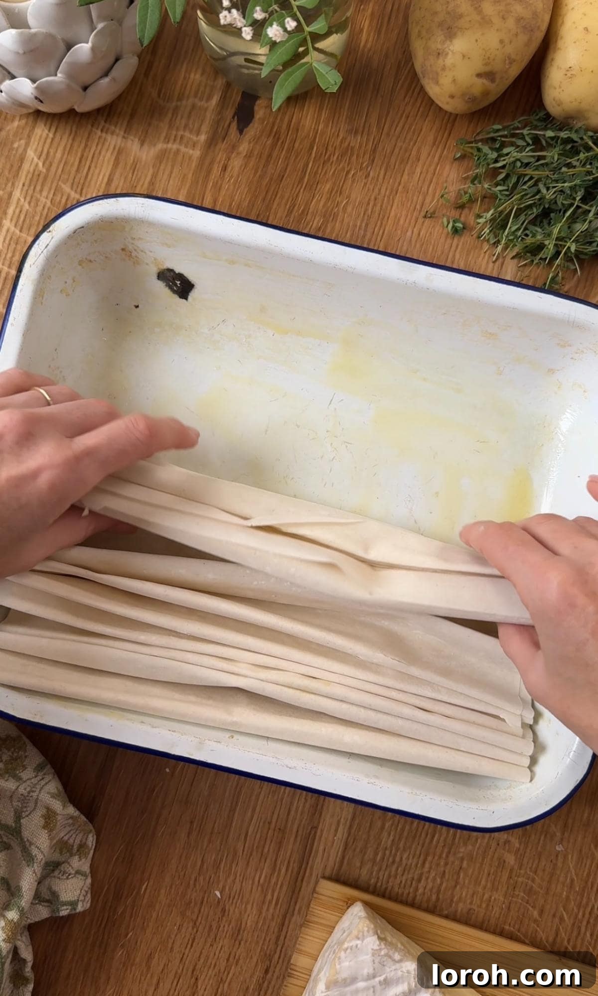Golden Filo-Wrapped Potato Tart with Melted Brie and Crispy Pancetta 4 Step one: Folding filo pastry sheets into a concertina shape and arranging them in a baking dish, brushing with butter.