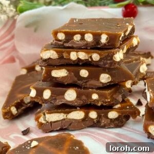 christmas pretzel crack stacked on a tray.