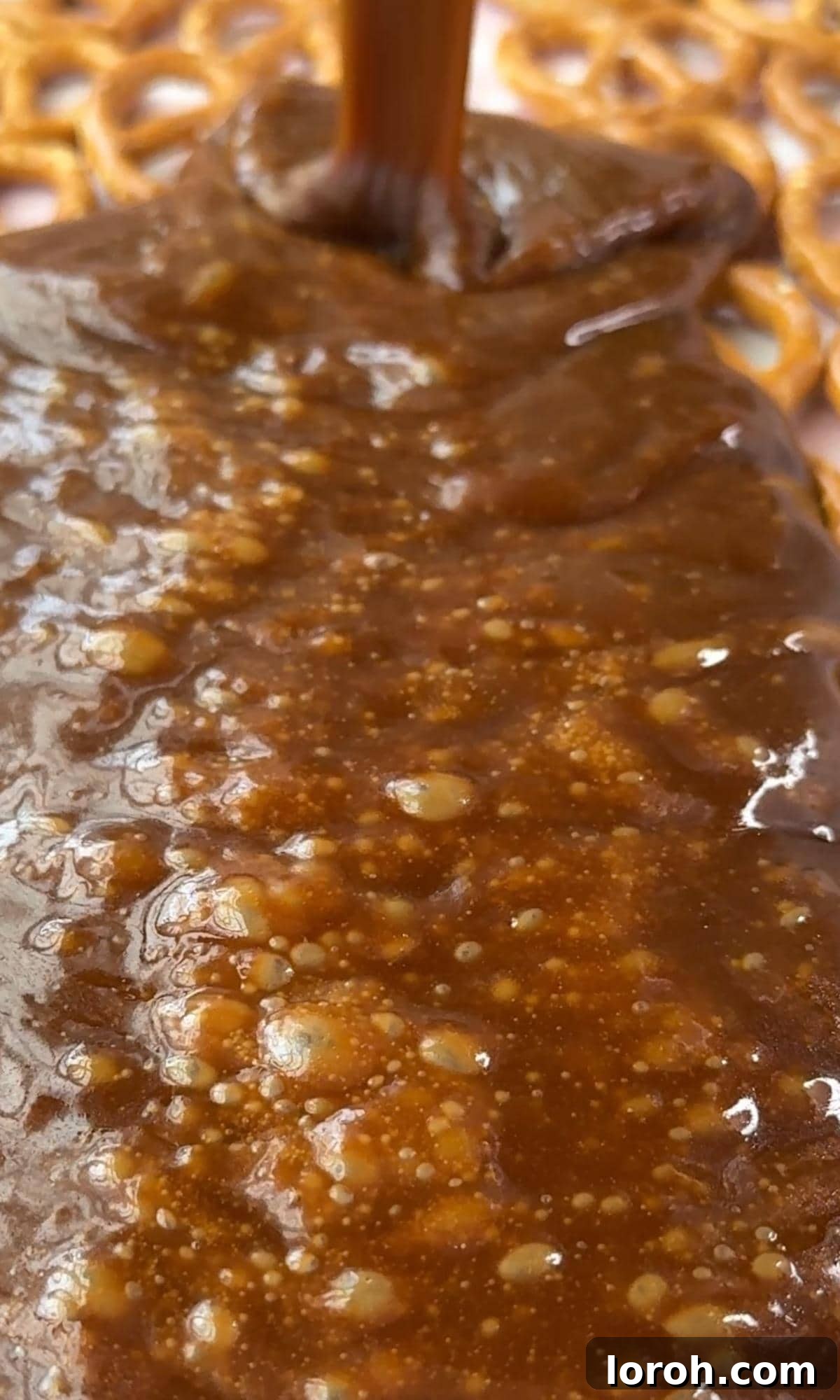Yuletide Pretzel Crack 7 Pouring the hot, bubbling toffee evenly over the layer of pretzels.