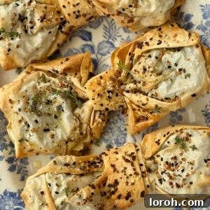 A close-up of a beautifully golden and crisp spinach feta filo bow on a blue plate.