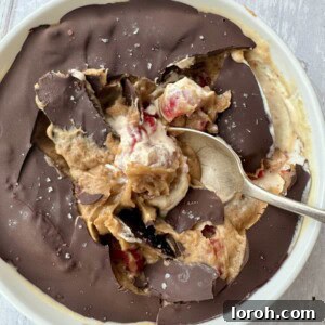 A vibrant peanut butter and yogurt bowl, artfully drizzled with homemade date caramel, perfect for a healthy and satisfying meal.