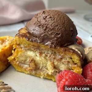 A decadent Hong Kong French toast served on a plate with fresh raspberries and a generous dollop of chocolate whipped cream.